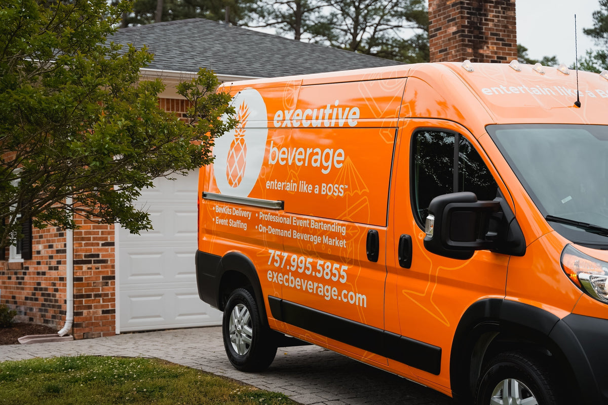 The orange Executive Beverage delivery van parked outside a home in Hampton Roads.