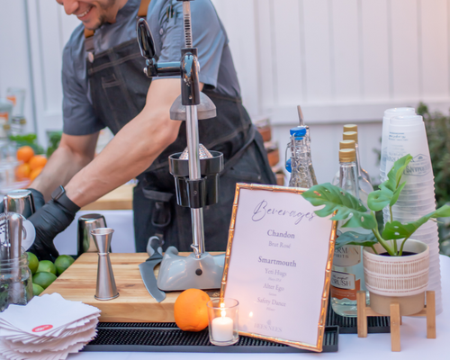 An Executive Beverage bar professional setting up a fresh pressed crush bar in Virginia Beach.