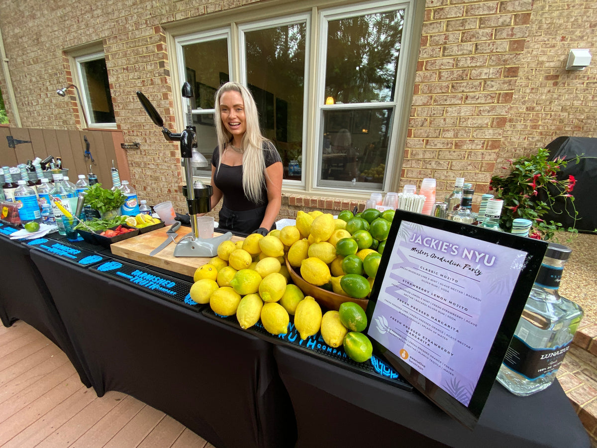 An Executive Beverage bartender behind a full backyard bar at a Hampton Roads family party