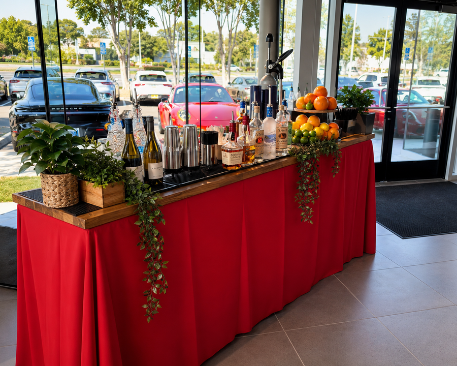 Long draped service bars set up for a high-volume outdoor reception