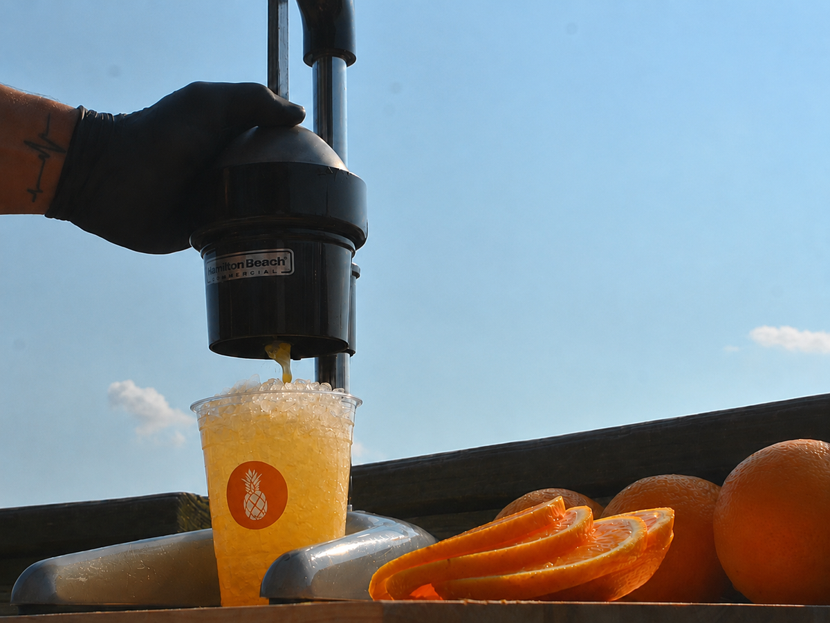 An Executive Beverage Crush Kit with a crusher, bar tools, fresh oranges and Waterman's Perfect Crush