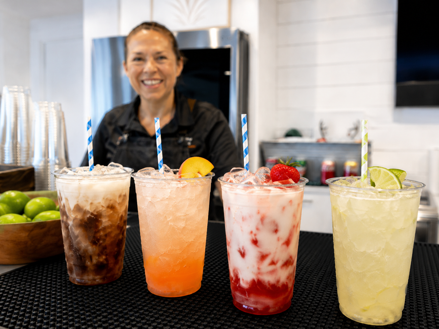 An Executive Beverage bartender behind a row of dirty sodas in Virginia Beach