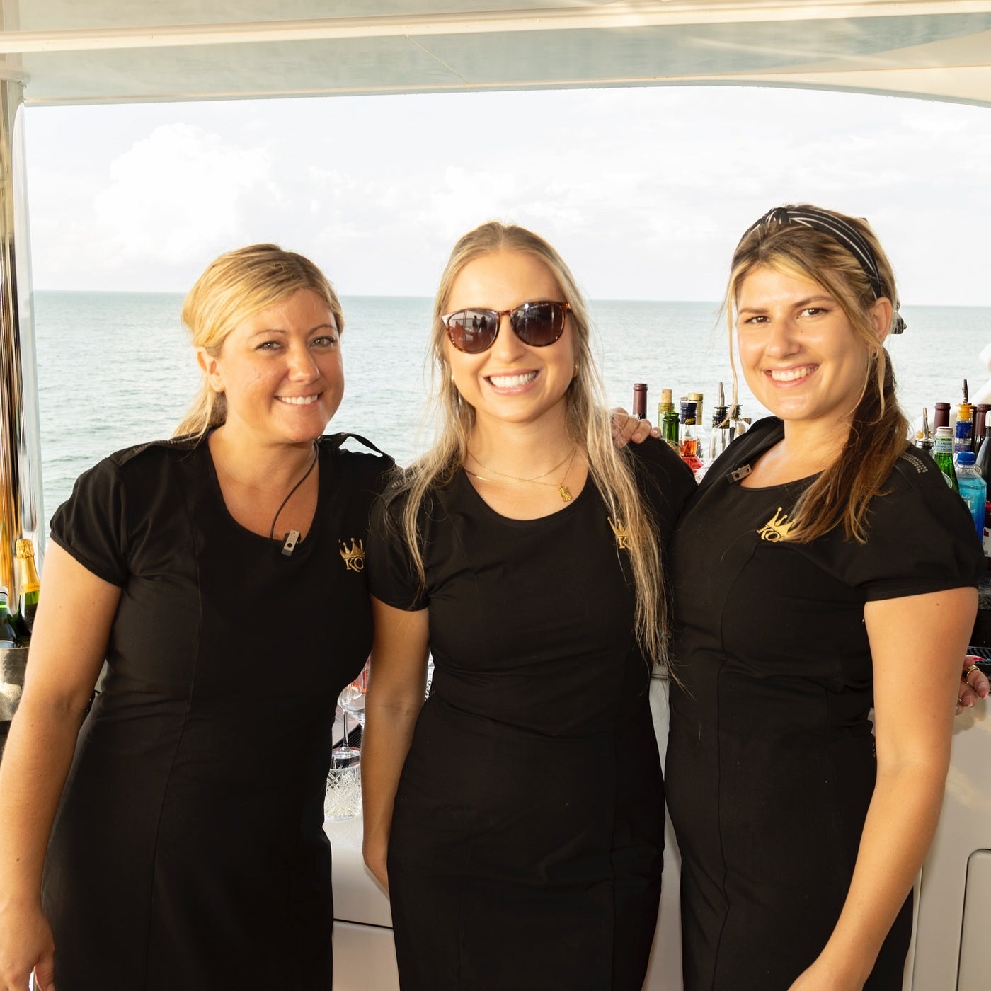 Three Executive Beverage waitstaff in black uniform ready to serve at a waterfront event in Virginia Beach