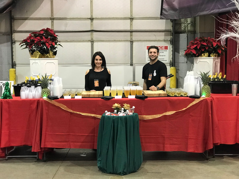 A holiday bar set up at Richmond International Raceway for the Bizarre Bazaar, staffed by two Executive Beverage bartenders.